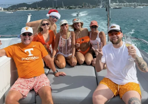 Happy group of people on a chillaxin charter boat celebrating super bowl weekend